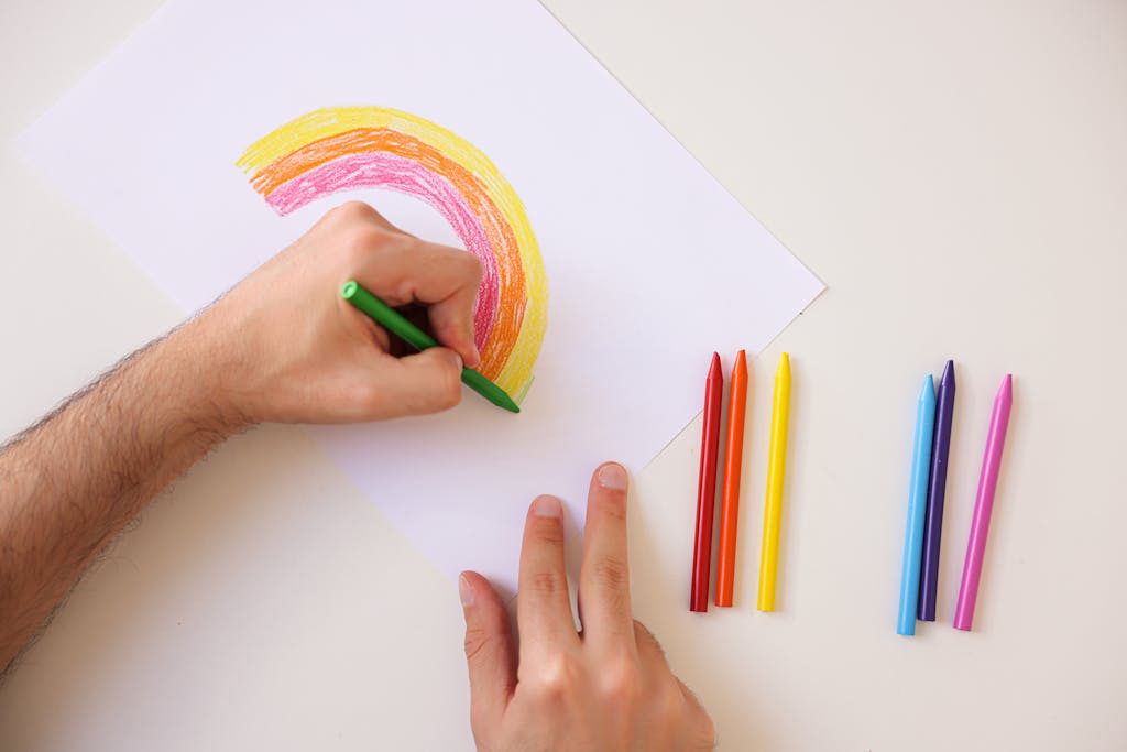 A Hand Drawing on a Bond Paper Using Green Colored Crayon